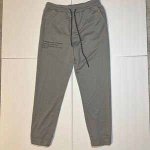 SHEIN Pants in grey, with a quote on the right leg.  Size Medium